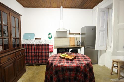 a kitchen with a table with a plate of fruit on it at Mountain House/ Serra da Estrela in Penhas da Saúde