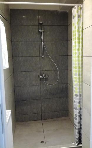 a shower with a glass door in a bathroom at Dip in the blue - 2 in Agios Georgios
