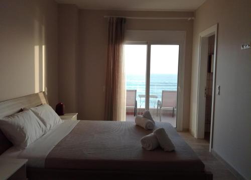 a bedroom with a bed with towels on it at Dip in the blue - 2 in Agios Georgios
