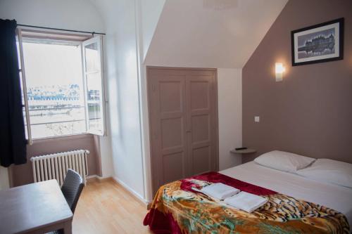 a small bedroom with a bed and a window at Le Pavillon in Blois