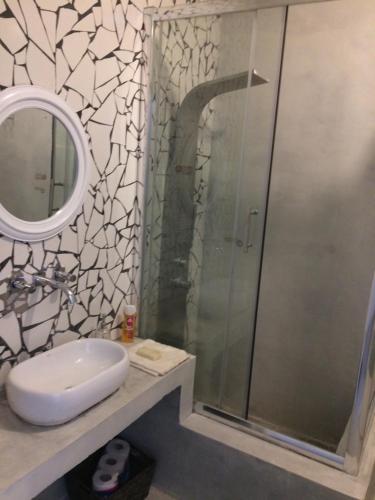 a bathroom with a shower and a sink and a mirror at Guatemala in Buenos Aires
