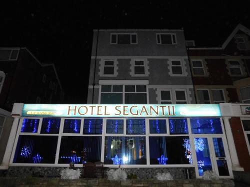
a building with a clock on the front of it at Hotel Segantii in Blackpool
