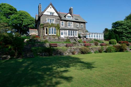a large house on a hill with a yard at Sawrey House in Near Sawrey