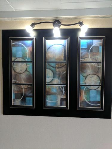 two stained glass windows on a wall with lights at Luxury Inn in Collingwood