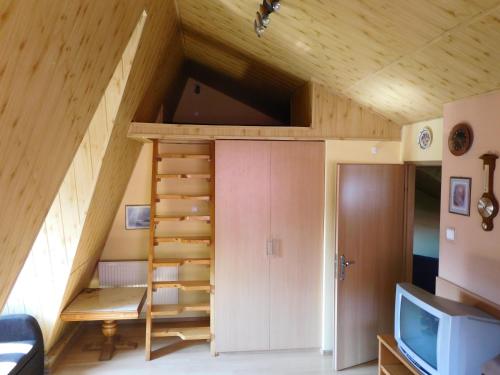 a tiny house with a staircase in the attic at Willa pod piórem in Szczyrk