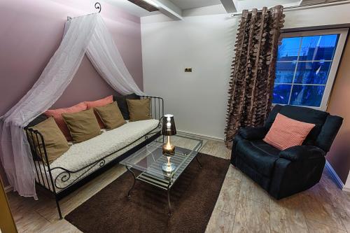 a living room with a couch and a chair at Chateau Nightingales in Hostouň