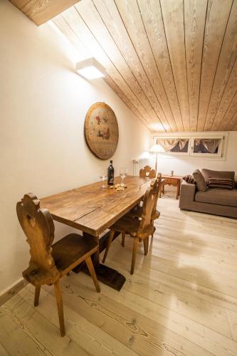 a dining room with a wooden table and chairs at Dimora Al Bivacco in Pieve di Cadore