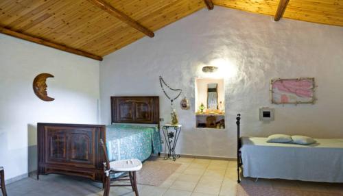 een slaapkamer met een bed en een stoel in een kamer bij Stazzu lu Malchesi in Arzachena