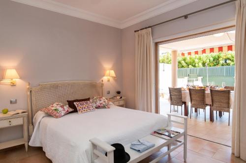 a bedroom with a bed and a dining room at Meloneras Hills 16 With Pool by VillaGranCanaria in Meloneras