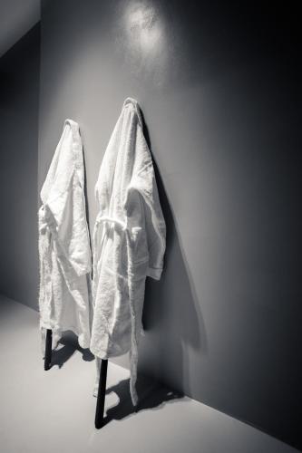 a room with a white robe on a wall at Dimora Al Bivacco in Pieve di Cadore