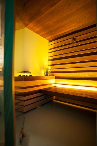 a sauna with a bench in a room at Dimora Al Bivacco in Pieve di Cadore
