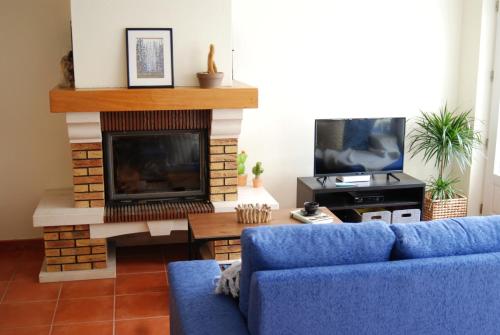 a living room filled with furniture and a tv at Hakuna Matata Hostel in Zambujeira do Mar