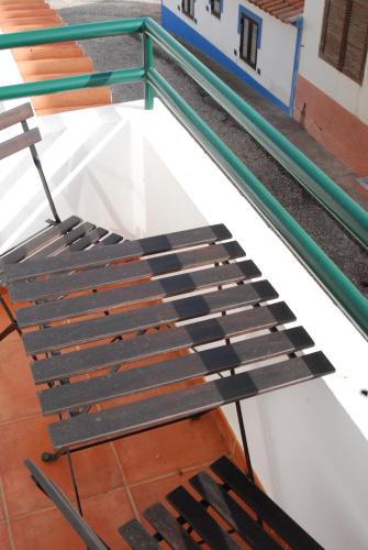 a bench sitting on top of a building at Hakuna Matata Hostel in Zambujeira do Mar