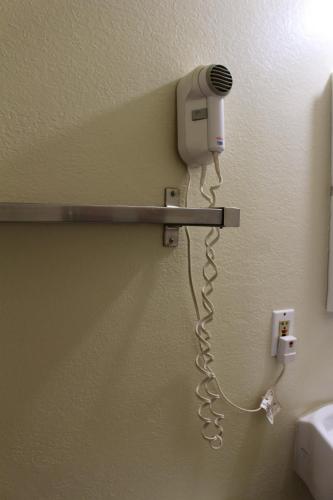 a hair dryer attached to a wall in a bathroom at Starlite Motel in Mesa
