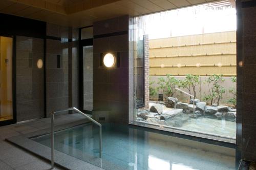 a pool in the middle of a building at Route Inn Grantia Shiretoko -Shari Ekimae- in Shari