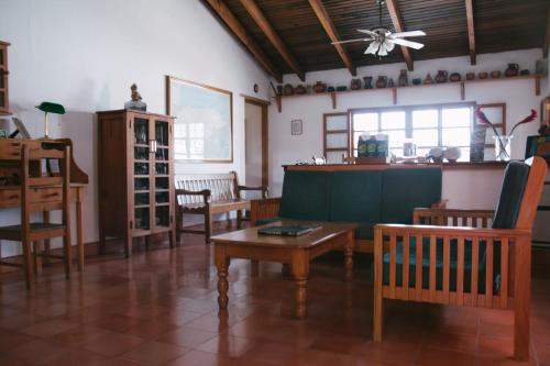 a living room with wooden chairs and a table at La Casa de Cafe Bed and Breakfast in Copán Ruinas