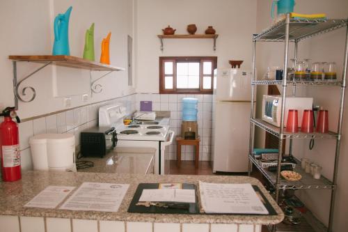 a kitchen with a stove and a refrigerator at La Casa de Don Santiago Townhouse in Copán Ruinas
