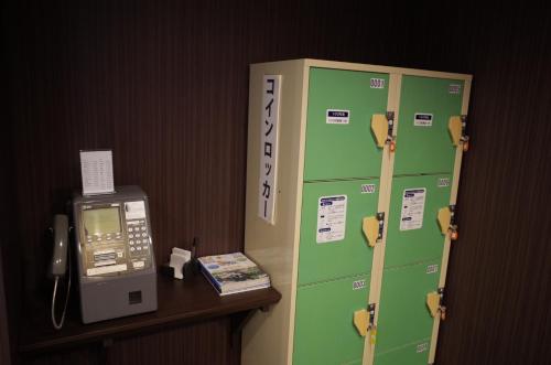 a phone booth and a cash register in a room at Miyakonojo Green Hotel in Miyakonozyō