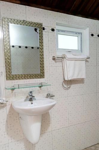 a bathroom with a sink and a mirror at Phong Nha River House in Phong Nha