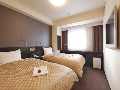 En eller flere senge i et værelse på Hotel Nanvan Hamanako