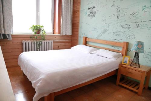 Cama o camas de una habitación en Harbin North International Youth Hostel
