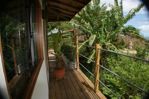 a balcony of a house with a potted plant at Villa Girassol in Ilhabela
