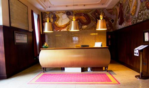a lobby with a reception desk in a building at Hotel Palacio de la Magdalena in Soto del Barco