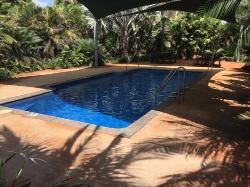 a swimming pool with blue water in a resort at Roebuck Plains Roadhouse in Broome