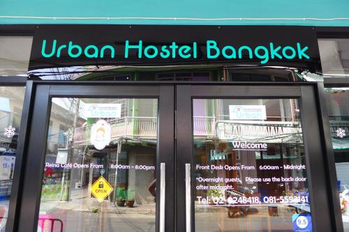 a sign on the front door of a hotel lobby at Urban Hostel Bangkok in Bangkok