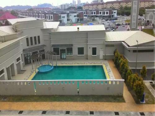 an aerial view of a building with a swimming pool at Seri Endon Apartment in Shah Alam