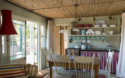 a kitchen with a table and chairs and a dining room at Vredenhof Farm Cottage in Elgin