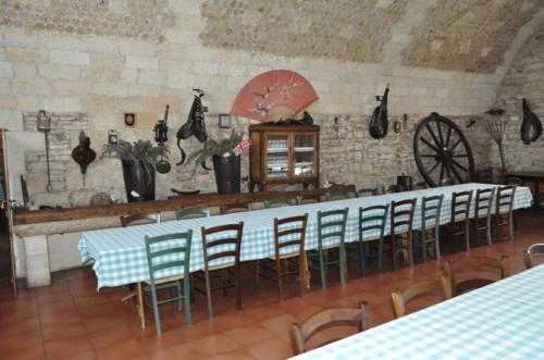 a room with a long table and chairs in a building at Tenuta Tannoja in Andria