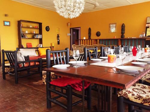 a dining room with a long table and chairs at Kokodo Guest House in Cape Coast