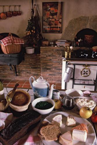 a table topped with a bunch of food on a table at Le Hameau de Barboron in Savigny-lès-Beaune