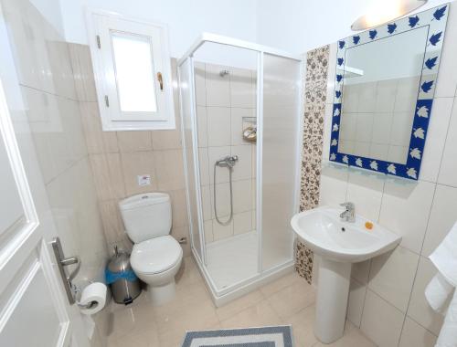 a bathroom with a shower and a toilet and a sink at Dream Island Hotel in Livadia