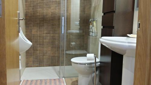 a bathroom with a shower and a toilet and a sink at Casa Txema in Lorca