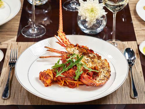 a white plate of food on a table at Four Seasons Hotel Jakarta in Jakarta