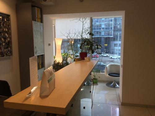 a room with a wooden counter with a large window at Partner Guest House in Kyiv