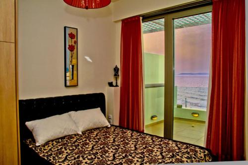 a bedroom with a bed with a view of the ocean at Sea View Beachfront Villa Peri in Gouves