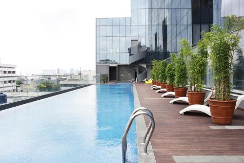 a row of pool tables in front of a large building at HARRIS Vertu Hotel Harmoni in Jakarta