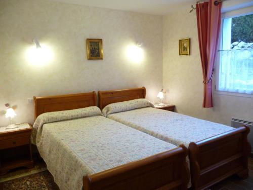 a bedroom with two beds and a window at Chambres d'Hôtes La Balaguère in Cauterets