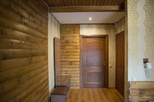 a hallway with wooden walls and a wooden door at Hotel & Restaurant Complex HAP-OK in Brodki