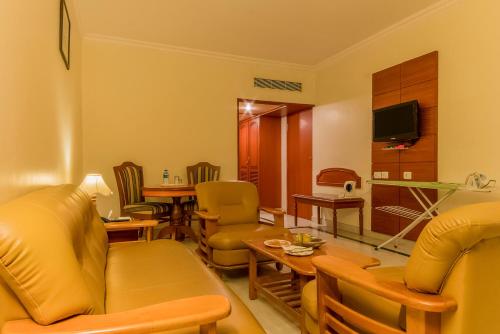 a living room with a couch and a table at Hotel Annamalai International in Puducherry
