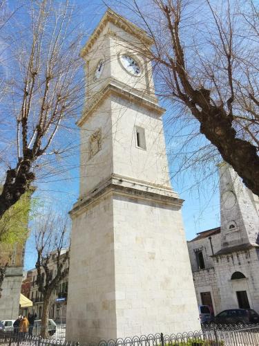 a tall tower with a clock on top of it at Le Statuine Dimore Diffuse in Barletta