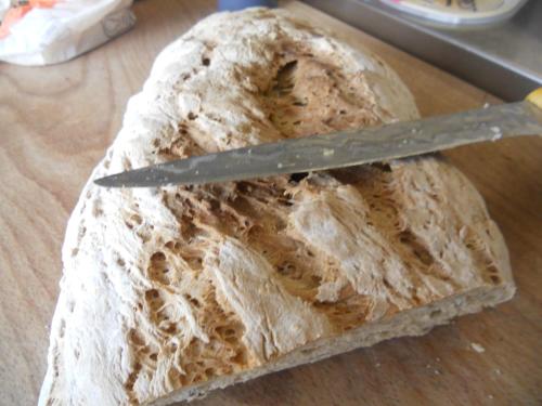 a loaf of bread with a knife on a table at Chez Louis chambres d'hôtes à la ferme in La Canourgue
