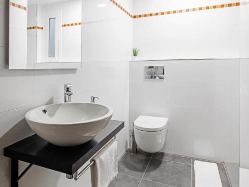 a white bathroom with a sink and a toilet at UNIK. Apartments Valencia in Valencia