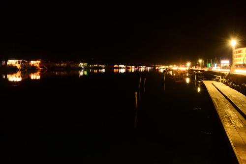 a city at night with a body of water at Lake Palace Group Of House Boats in Srinagar