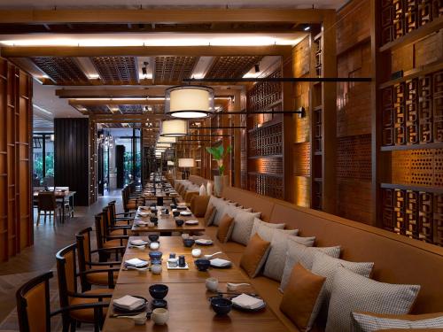 a long dining room with long tables and chairs at Shangri-La Jakarta in Jakarta