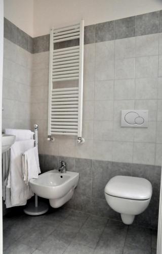 a bathroom with a toilet and a sink at Hotel Holiday Beach in Rimini