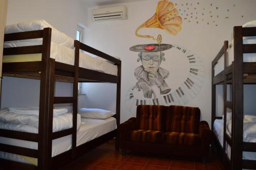 a room with two bunk beds and a couch at Arka Hostel in Shkodër